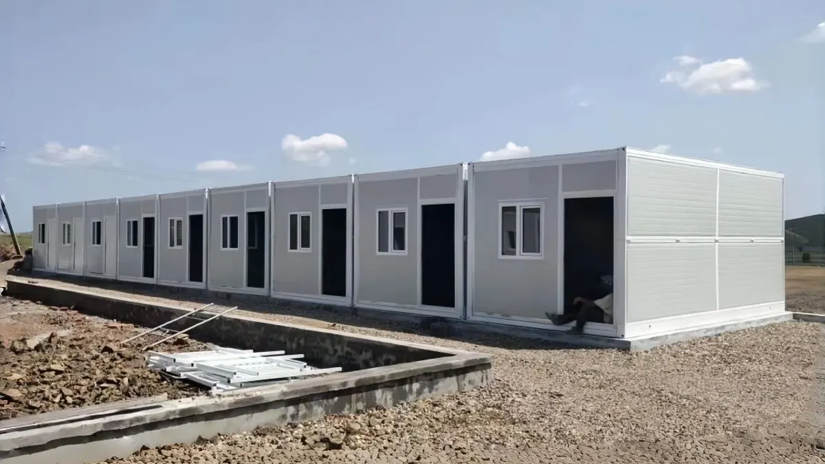 Row of modular worker accommodation units installed along a prepared North American project site
